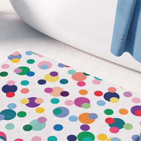 A vibrant and playful microfiber bath mat for kids, adorned with colorful polka dots in various sizes. Non-slip, quick-drying, and mold-resistant.