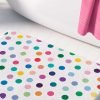 A white microfiber non slip bath mat for kids featuring a cheerful polka dot pattern in various vibrant colors. Mold and mildew resistant, plush, soft, machine washable, and quick drying.