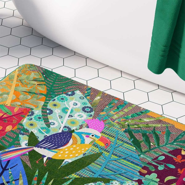 A kids' bath mat featuring a colorful jungle theme with a colorful bird.