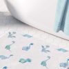 Blue dinosaur patterned bath mat for a baby boy's bathroom