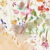 Close-up of delicate watercolor wildflowers on fabric shower curtain.