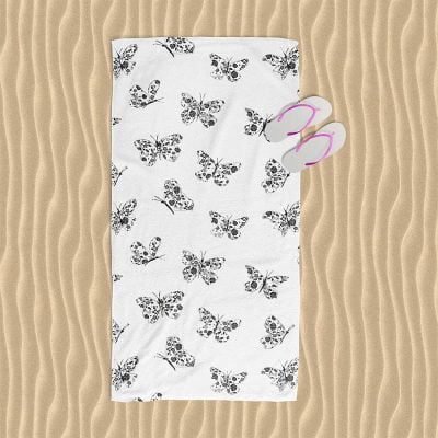 Beach towel with black and white abstract butterfly print, perfect for modern girls' beach outings.