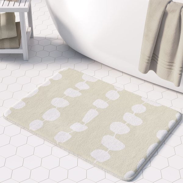 Coastal beige and white pebble striped designer microfiber non-slip bath mat in an elegant bathroom setting.